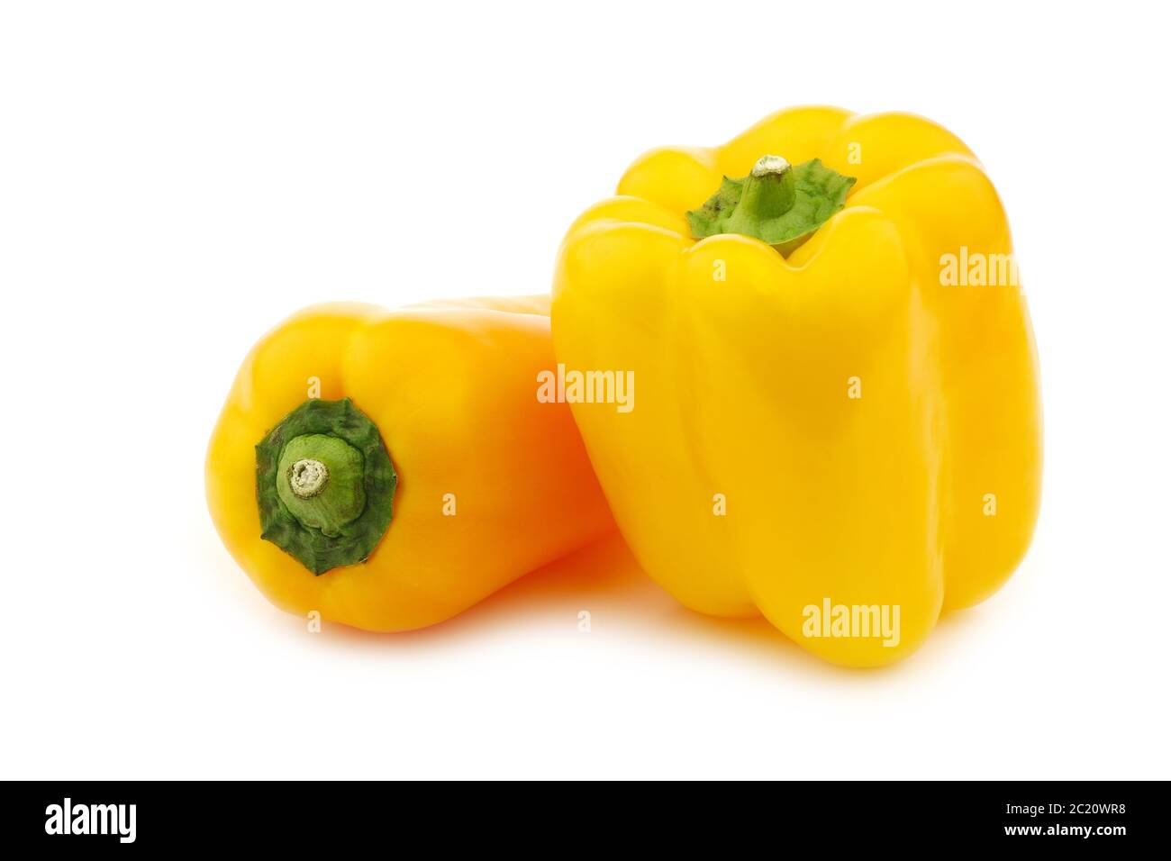 two fresh yellow bell peppers(capsicum) on a white background Stock