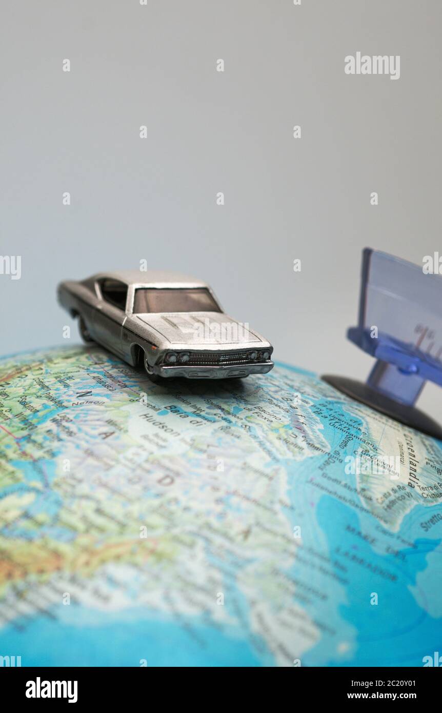 a toy car on top of world globe Stock Photo
