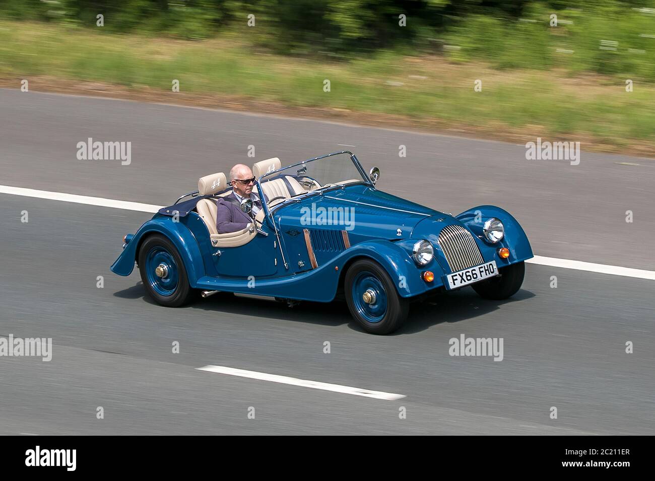 FX66FHO 2016 blue Morgan two seater  4/4 classic sports cars driving vehicle on UK roads, motors, leisure motoring on the M6 motorway Stock Photo