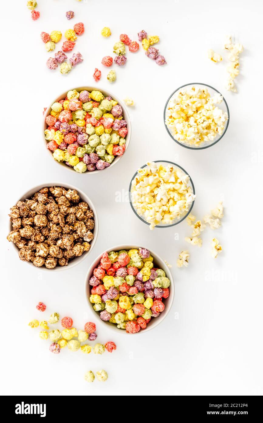 Flavored popcorn on white table top view Stock Photo