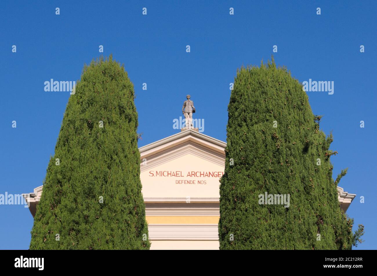roman catholic church (San Michele Arcangelo) between cypress trees, Colonno, Lake Como, Italy Stock Photo