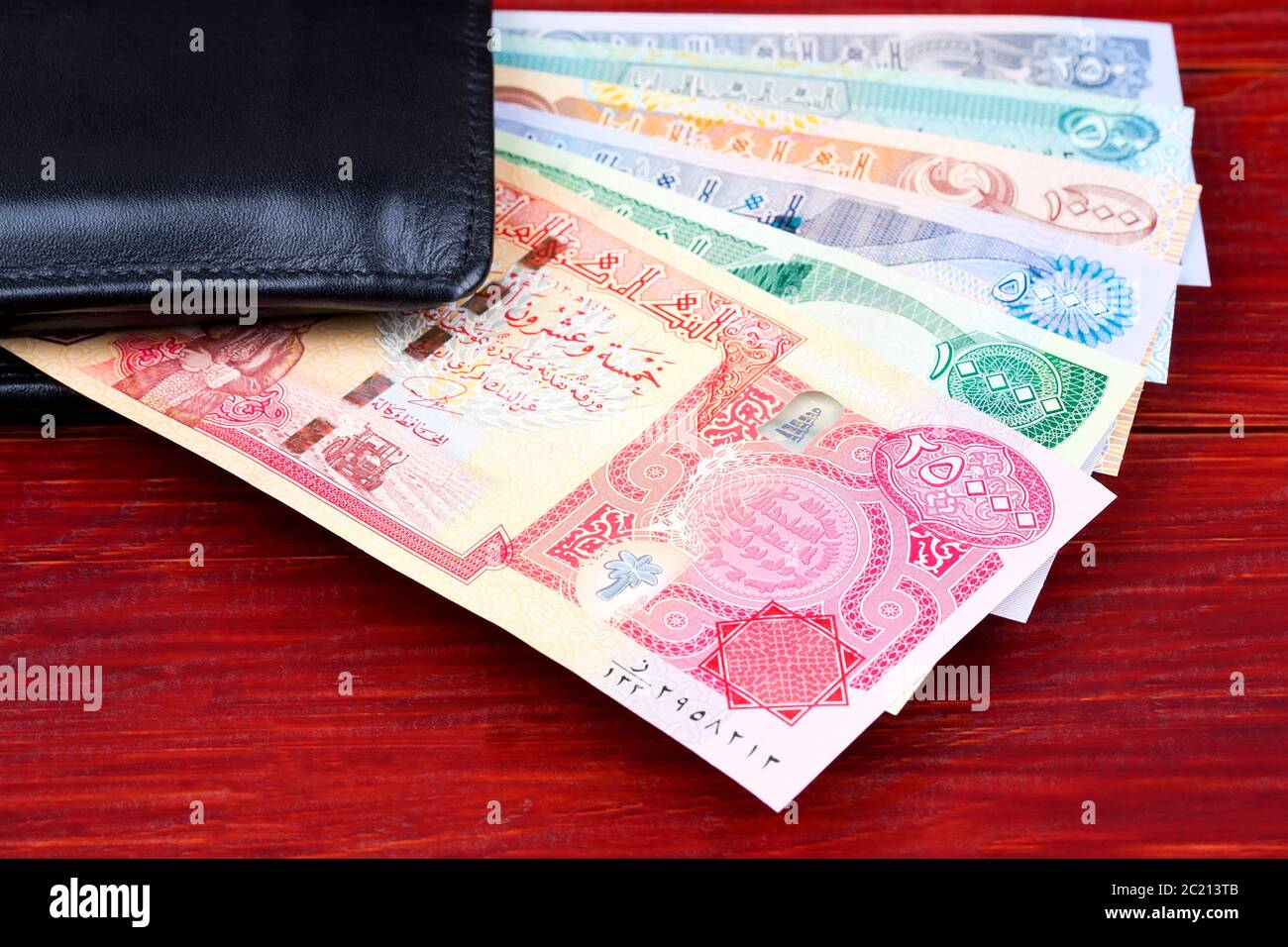 Iraqi Dinar in the black wallet Stock Photo