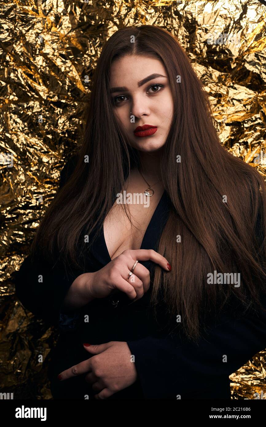 beautifull chubby girls Stylish chubby girl posing in a black jacket on a gold background Stock  Photo - Alamy