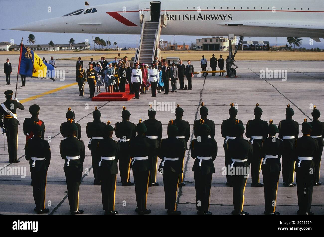 A guard of honour welcomes H.M. Queen Elizabeth & H.R.H. The Duke of Edinburgh arrival at Barbados via Concorde. Circa 1989 Stock Photo