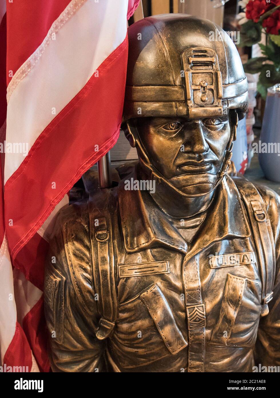 Outdoor statue and flag holder of a U.S. military soldier constructed