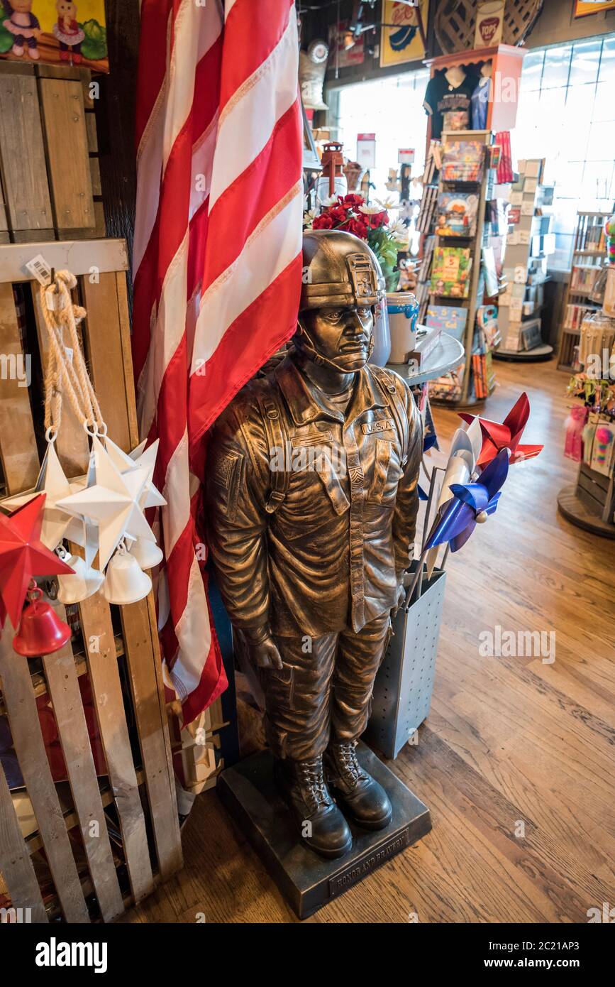Outdoor statue and flag holder of a U.S. military soldier constructed