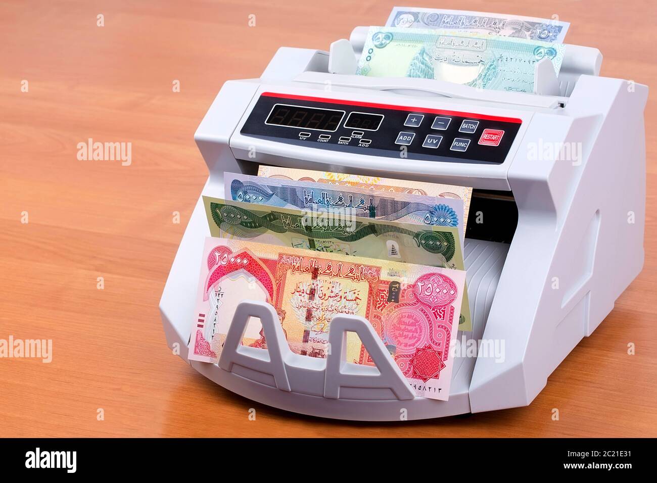 Iraqi Dinar in a counting machine Stock Photo