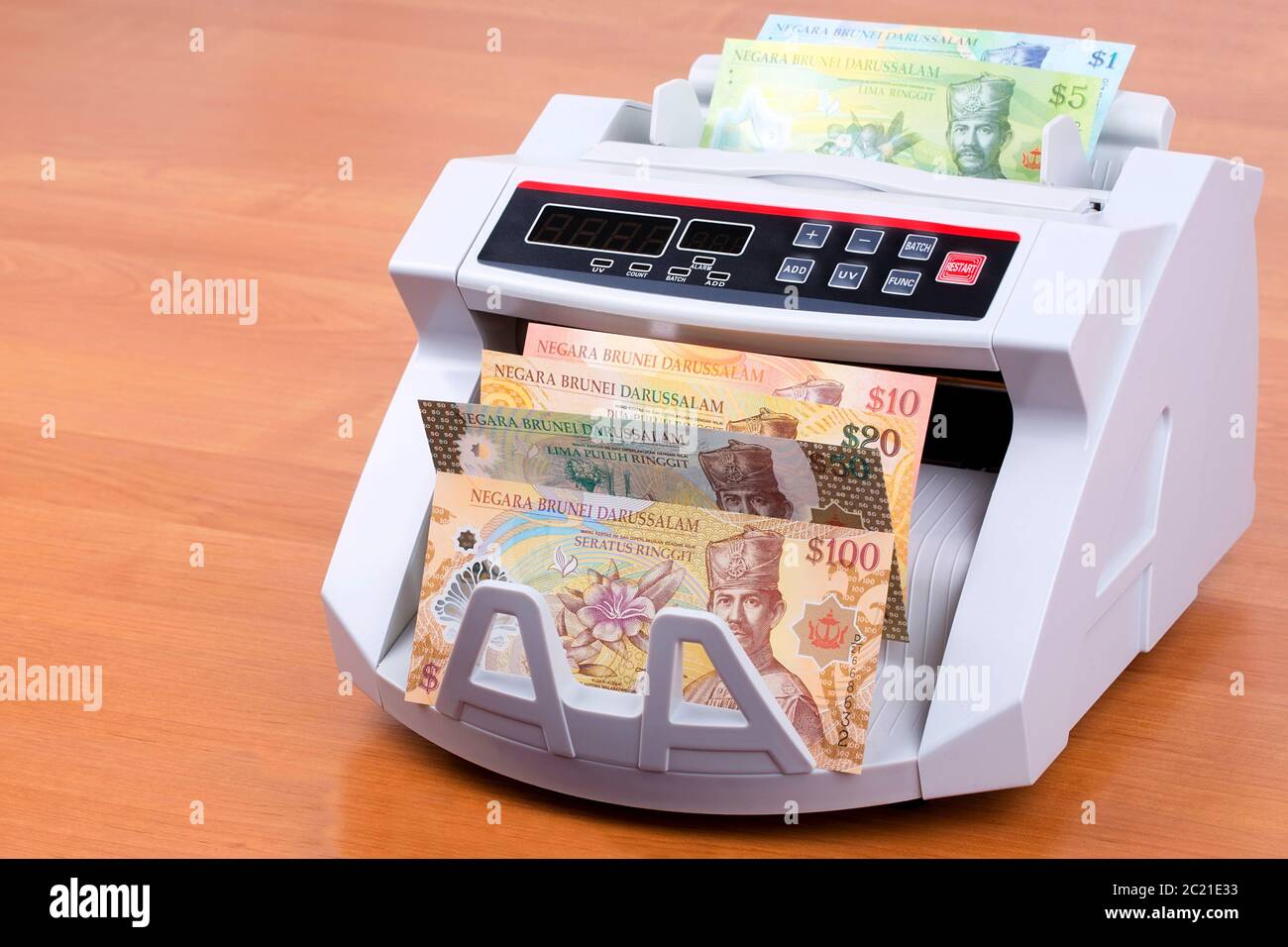 Brunei money in a counting machine Stock Photo Alamy