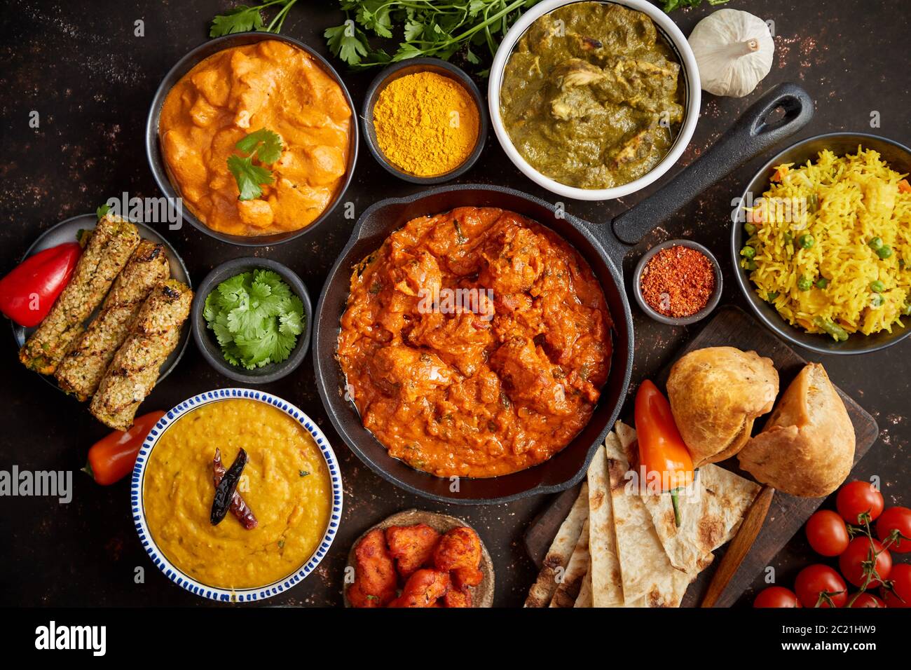 Assortment of various kinds of Indian cousine on dark rusty table Stock Photo