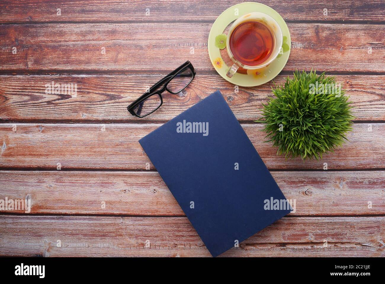 book with empty cover, pen and keyboard on table  Stock Photo