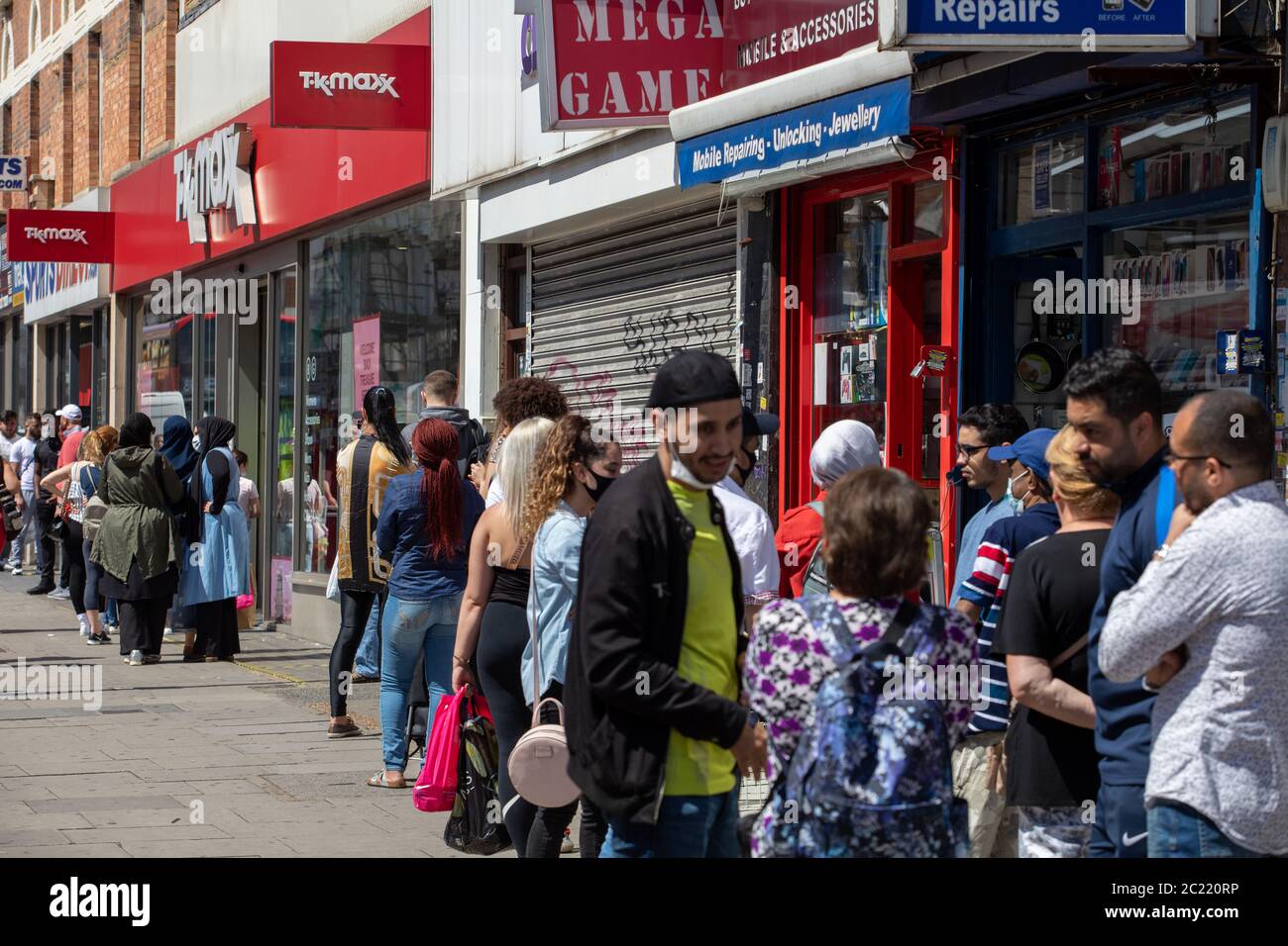 Kilburn High Road, London, England Non-essential shops reopen following the enforced closure in March 2020 due to Covid-19, Customers queue for TK Max Stock Photo