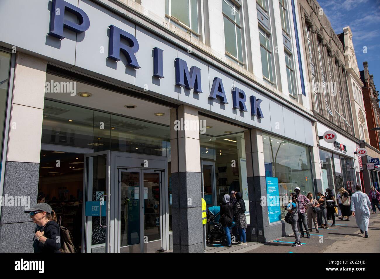 Customers queue following the reopening of non-essential shops following the Covid-19 lockdown. Pictured is Primark in Kilburn, London Stock Photo