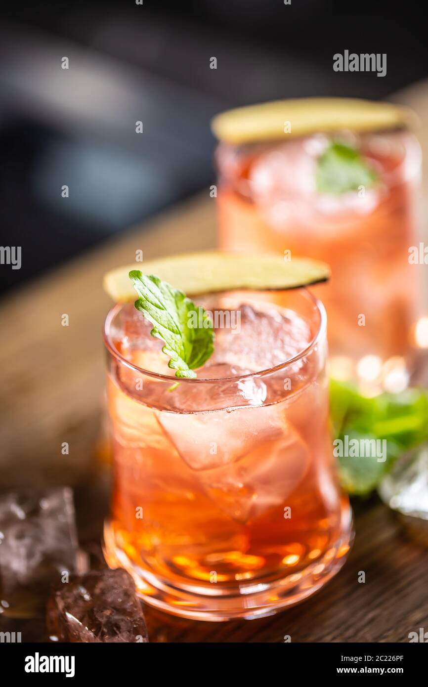 Cranberry cocktail sea breeze detail with ice and mint leaf Stock Photo