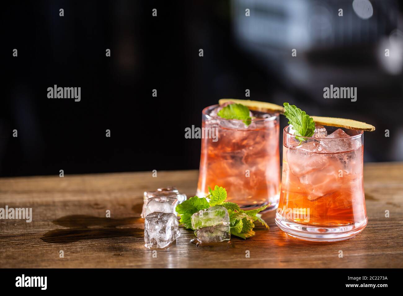 Cranberry lemonade in two glasses with ice on a dark background Stock Photo