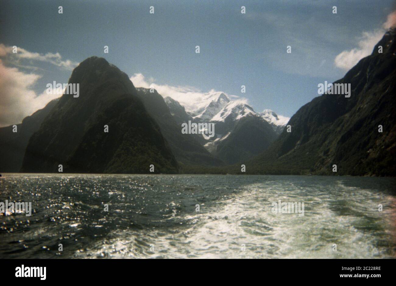 View from the sea looking into Milford Sound with snowcapped mountainsNew Zealand,Fjordland,Milford Sound Blue Sky,Milford Sound,Milford Sound New Ze Stock Photo