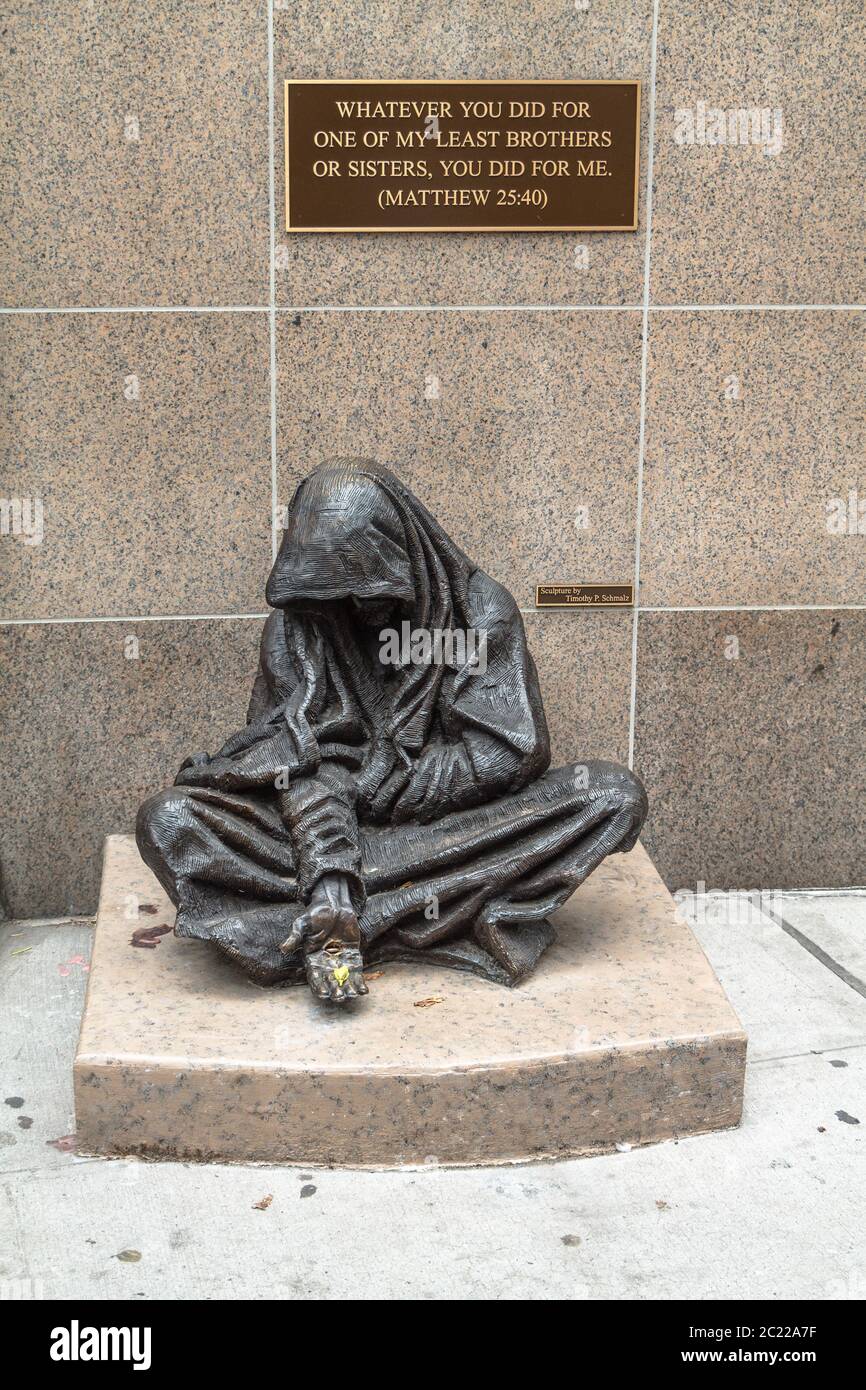 The When I Was Hungry and Thirsty statue of Jesus as a beggar by Timothy Schmalz in Manhattan Stock Photo