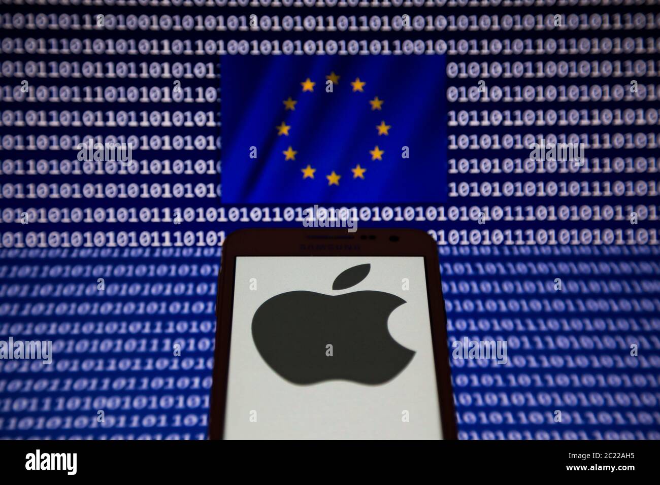 June 16, 2020, Asuncion, Paraguay: Illustration photo - Logo of Apple, a  technology company, is displayed on a smartphone backdropped by waving flag  of the European Union (EU) with binary code digits