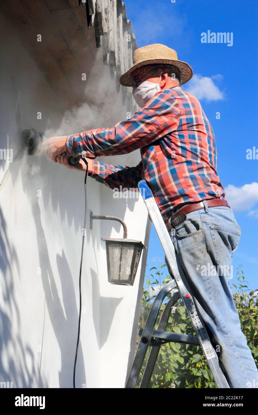 Sanding the house wall Stock Photo