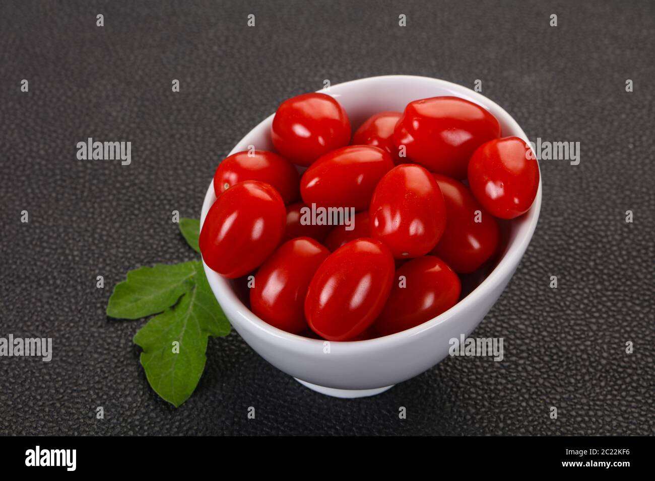 Sweet Red cherry tomatoes in the bowl Stock Photo - Alamy