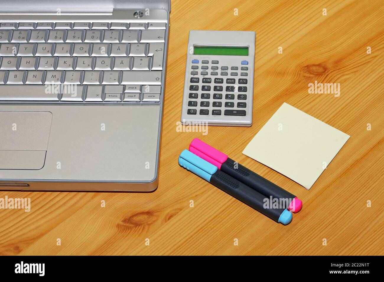 Silver Notebook Two Highlighter Pens Sticky Notes and Calculator Stock Photo