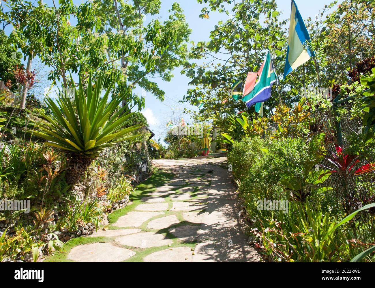 The sunny street with flags in Nine Mile village, the birthplace of reggae musician Bob Marley