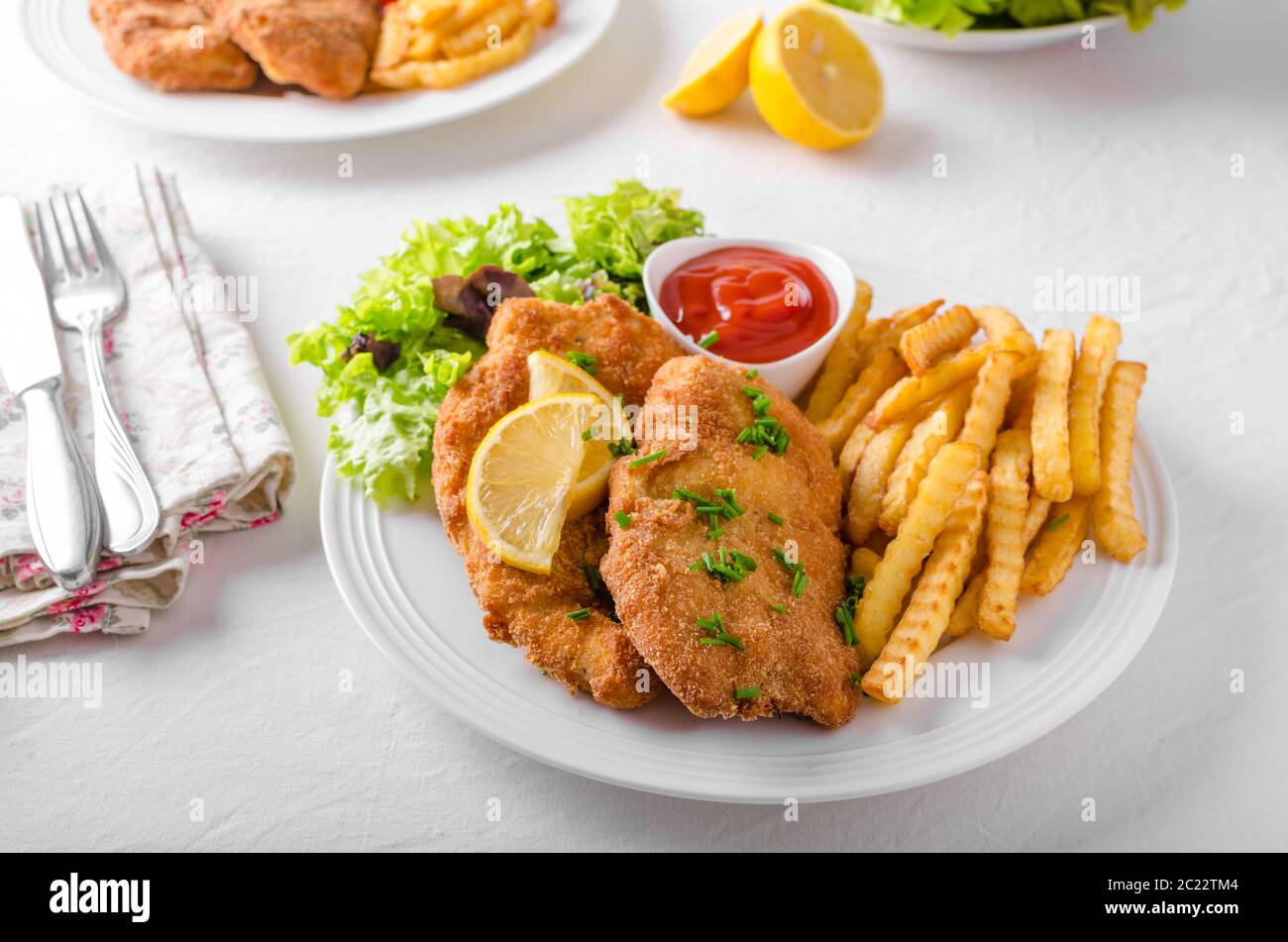 Wiener schnitzel with french fries, salad and a sharp dip Stock Photo ...