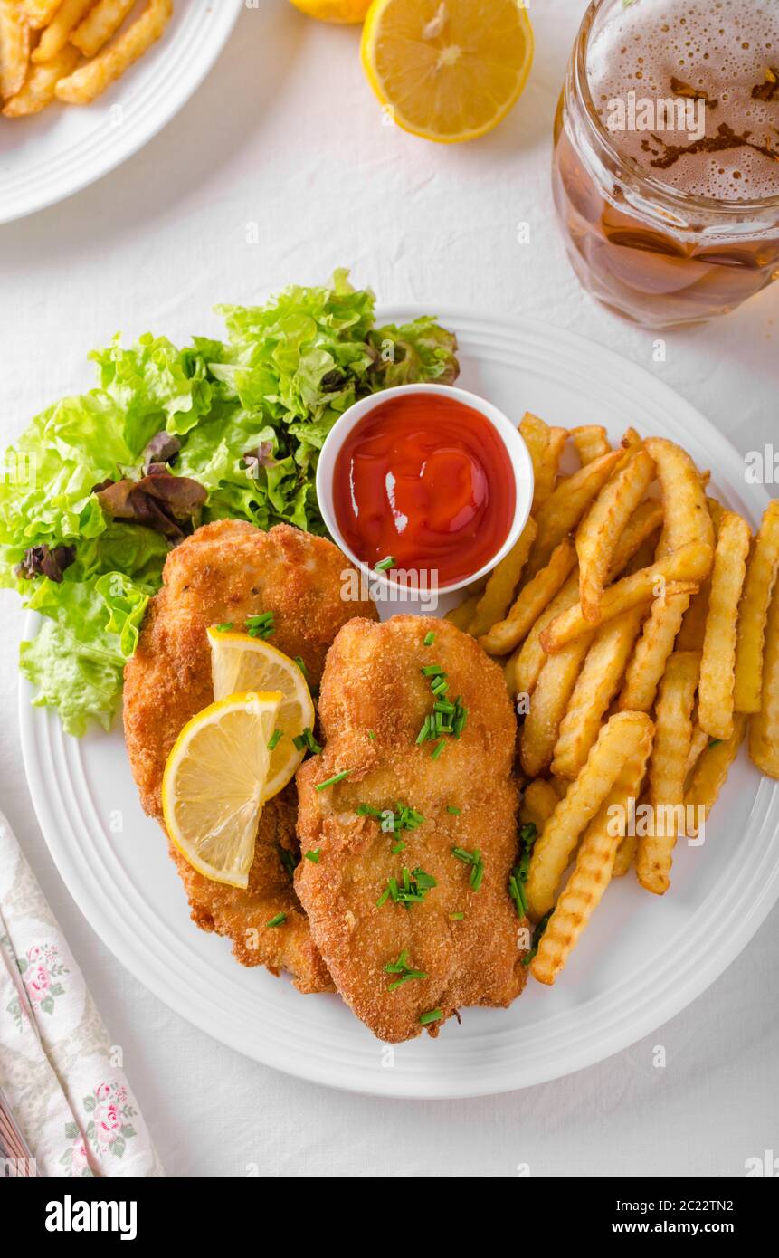 Wiener schnitzel with french fries, salad and a sharp dip Stock Photo ...