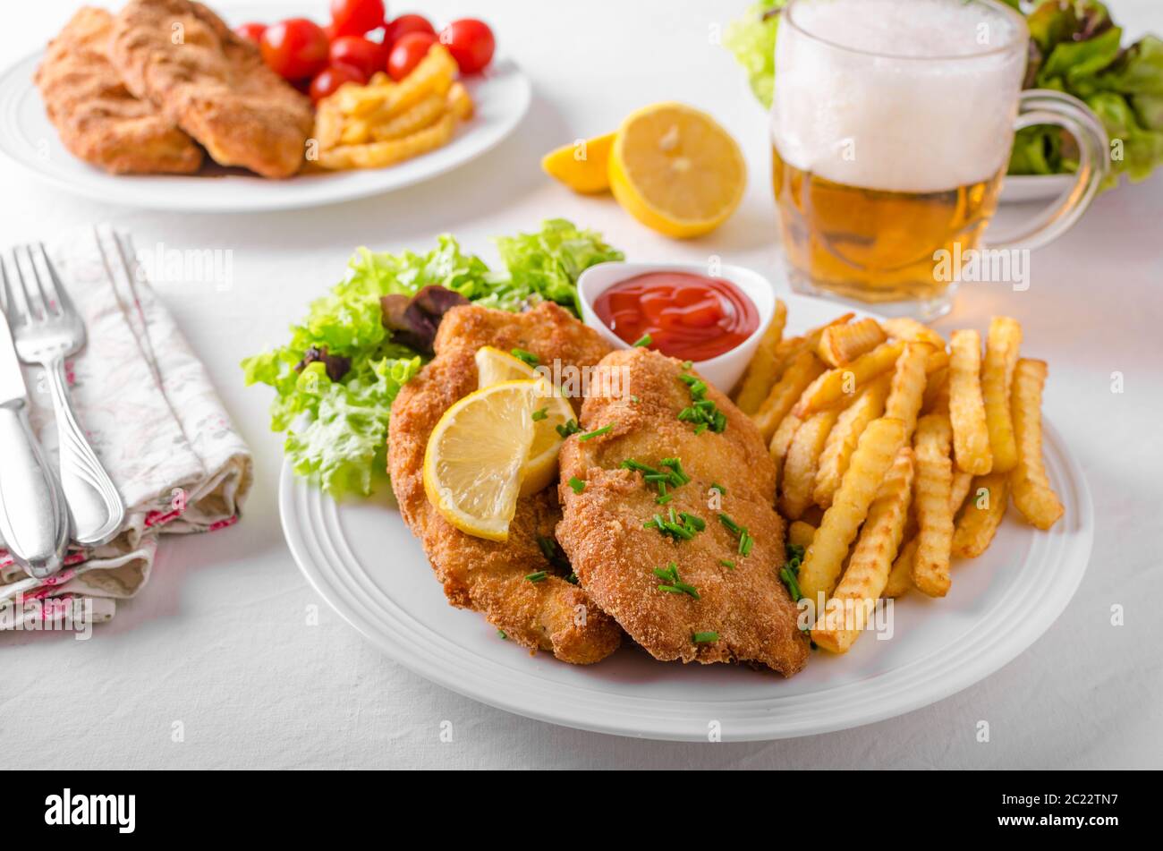 Wiener schnitzel with french fries, salad and a sharp dip Stock Photo ...