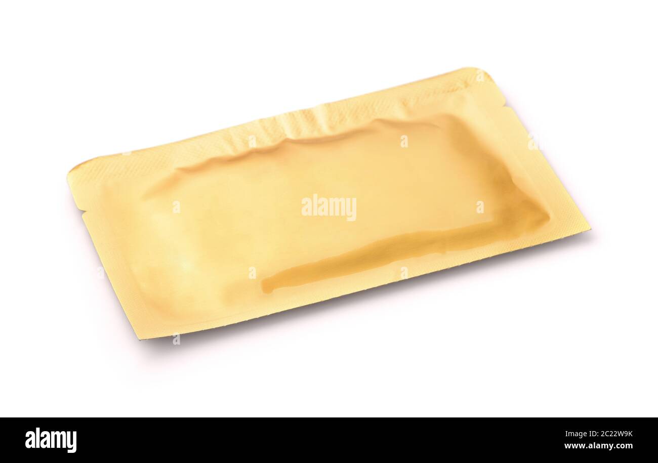 Golden sealed cosmetics sachet isolated on white Stock Photo