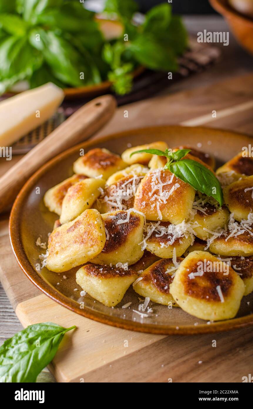 Roasted gnocchi with garlic and Parmesan, delicious crispy food Stock