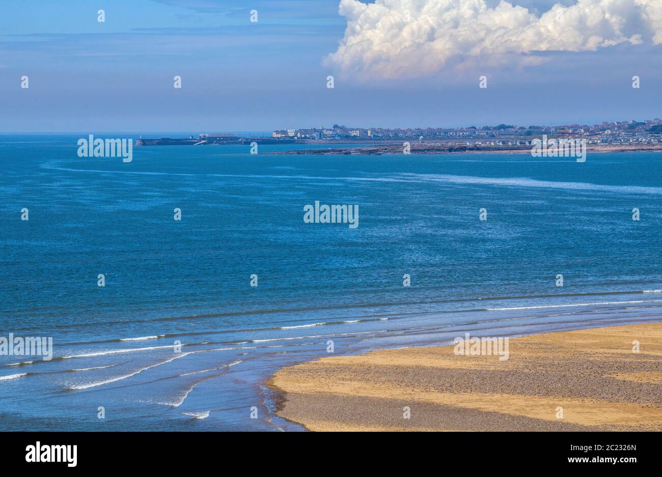 The South Wales coast at Ogmore by Sea in south Wales looking towards Porthcawl woth the sandy beach in the foreground and a blue sea and sky behind. Stock Photo
