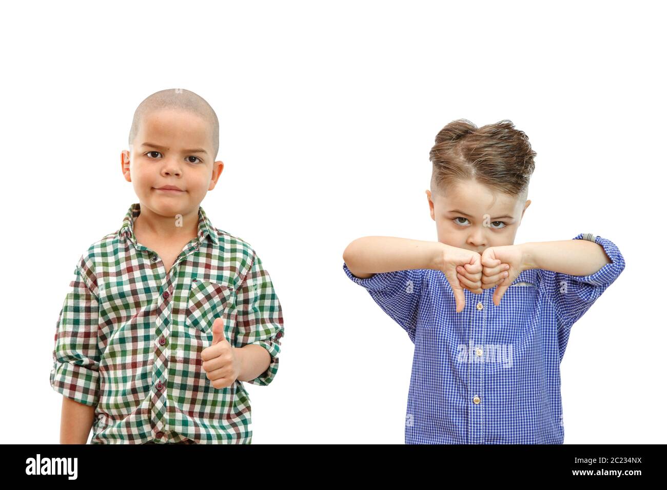 two boy with thumbs up and thumbs down on white isolated backround Stock Photo