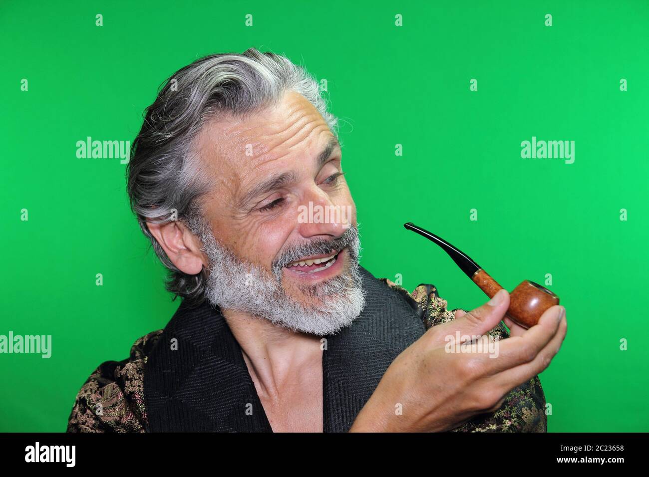 happy mature caucasian man smoking pipe Stock Photo