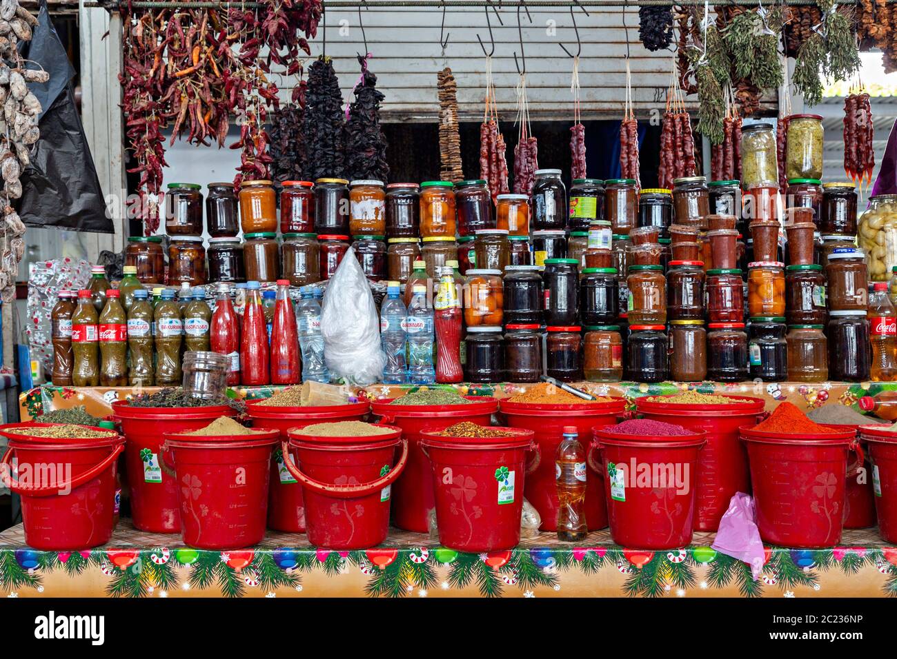 Different spices, dried food and jams in jars in the bazaar known as deserters bazaar, in Tbilisi, Georgia Stock Photo
