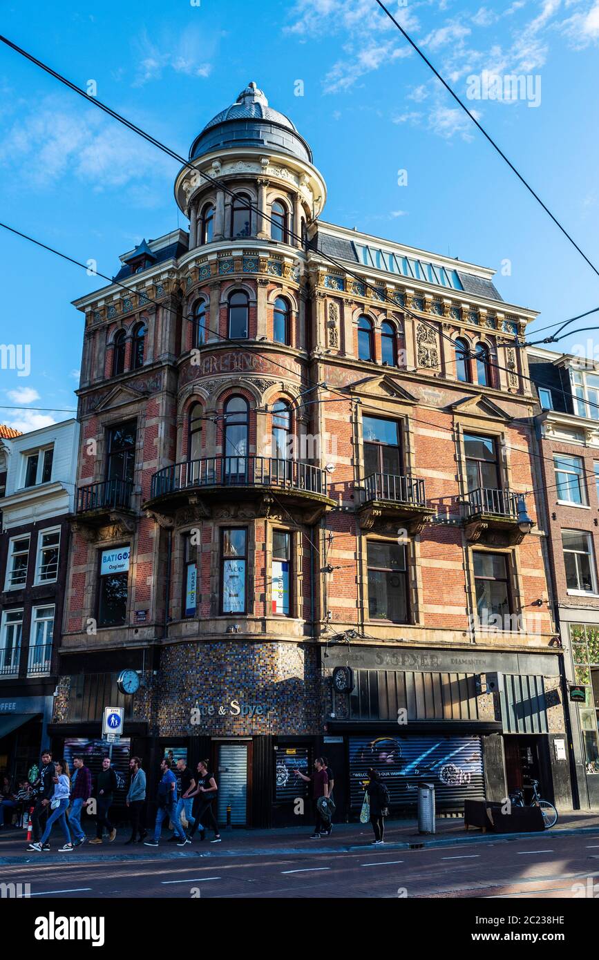 Amsterdam, Netherlands - September 9, 2018: Facade of an old classic building with people around in the old town of Amsterdam, Netherlands Stock Photo
