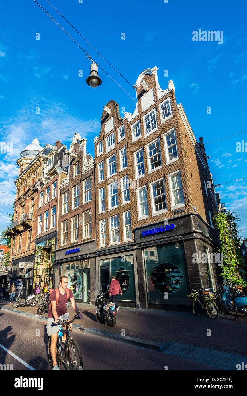 Amsterdam, Netherlands - September 9, 2018: Shopping street with people on a bike and Shoebaloo shop in the old town of Amsterdam, Netherlands Stock Photo