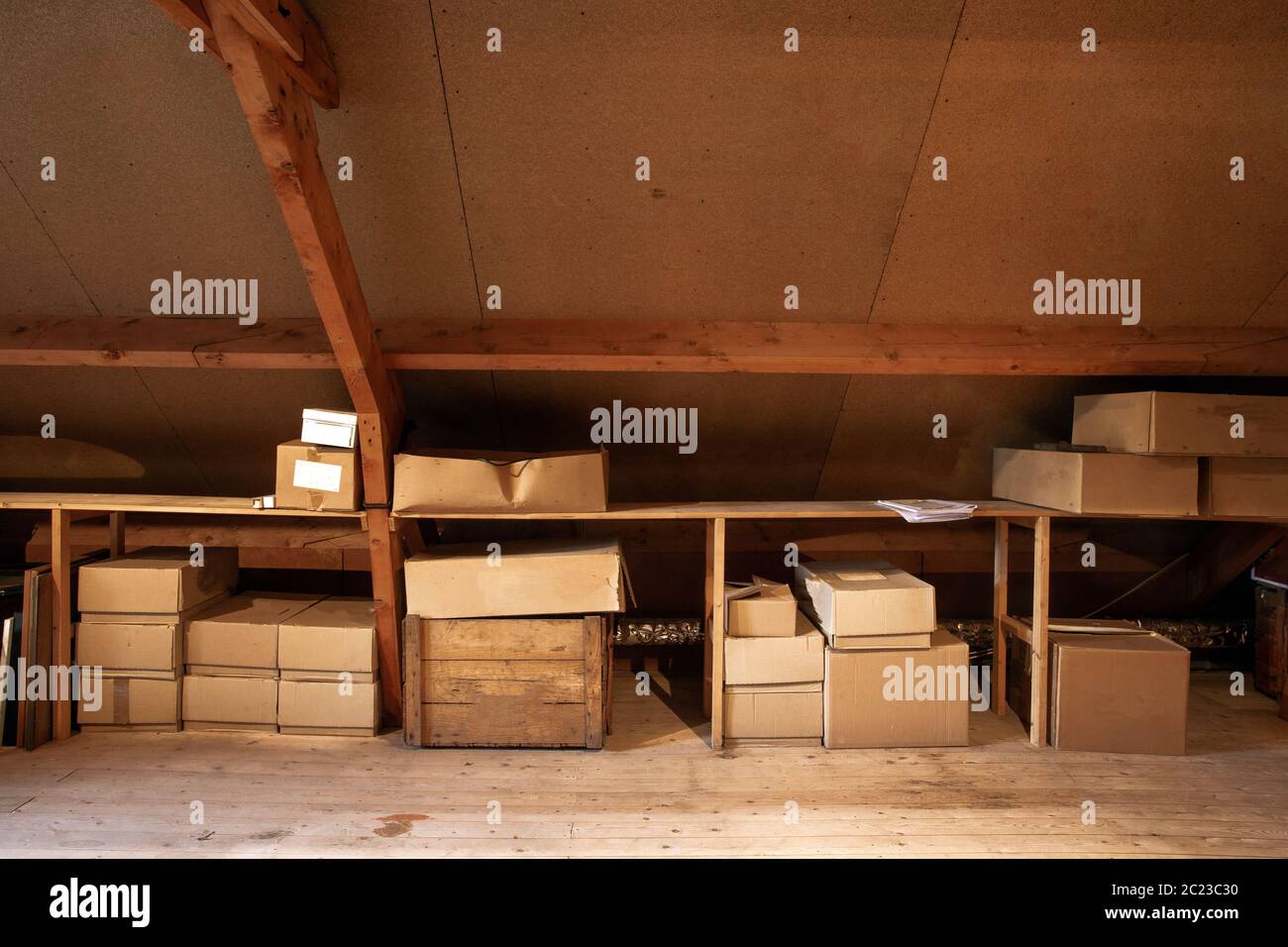 Old wooden attic interior with old cardboard boxes for storage or moving Stock Photo Alamy