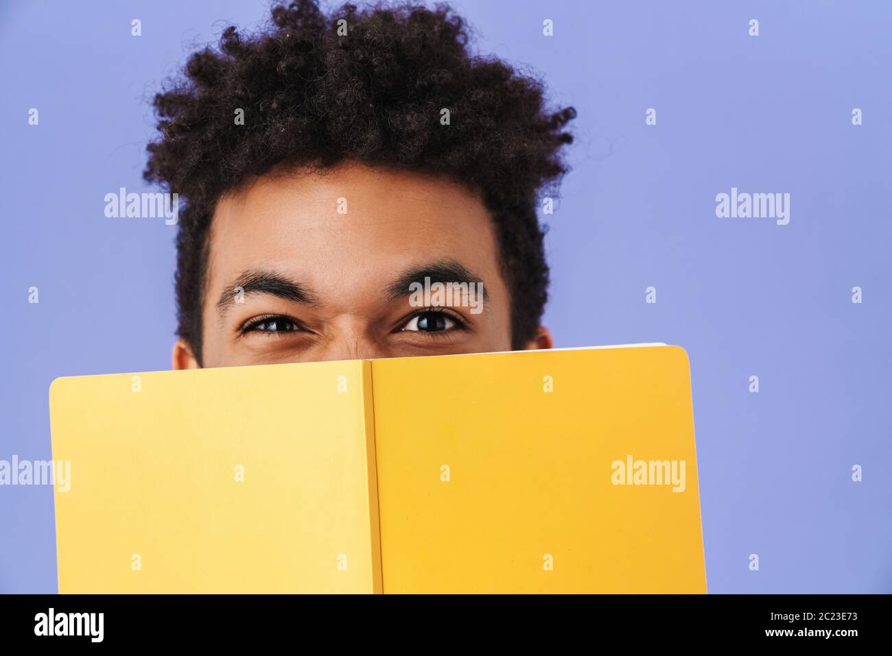 Photo of young african american man covering his face with exercise ...
