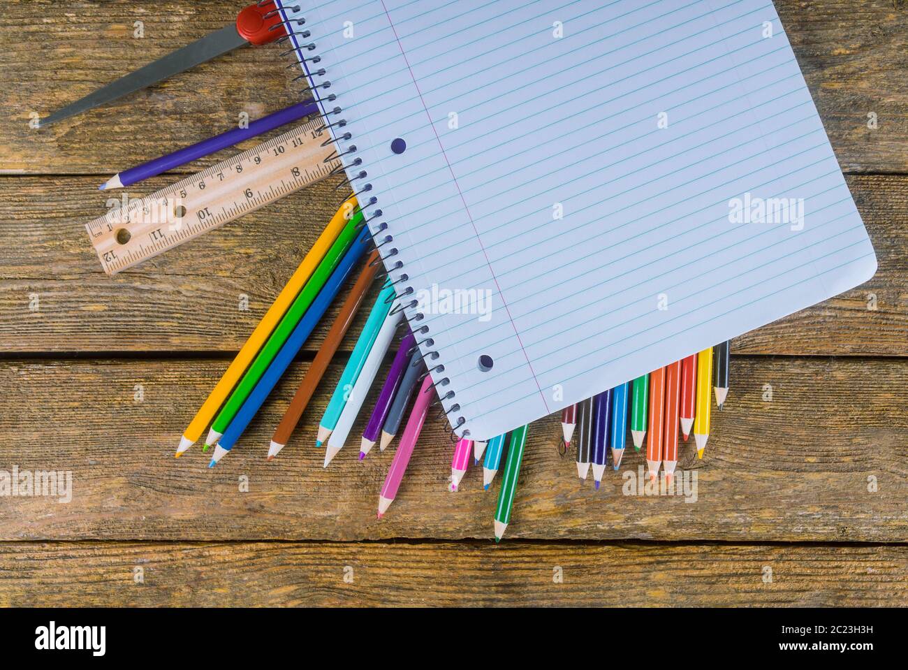 Assortment of colored pencils, ruler, glue and scissors on table Stock Photo Alamy