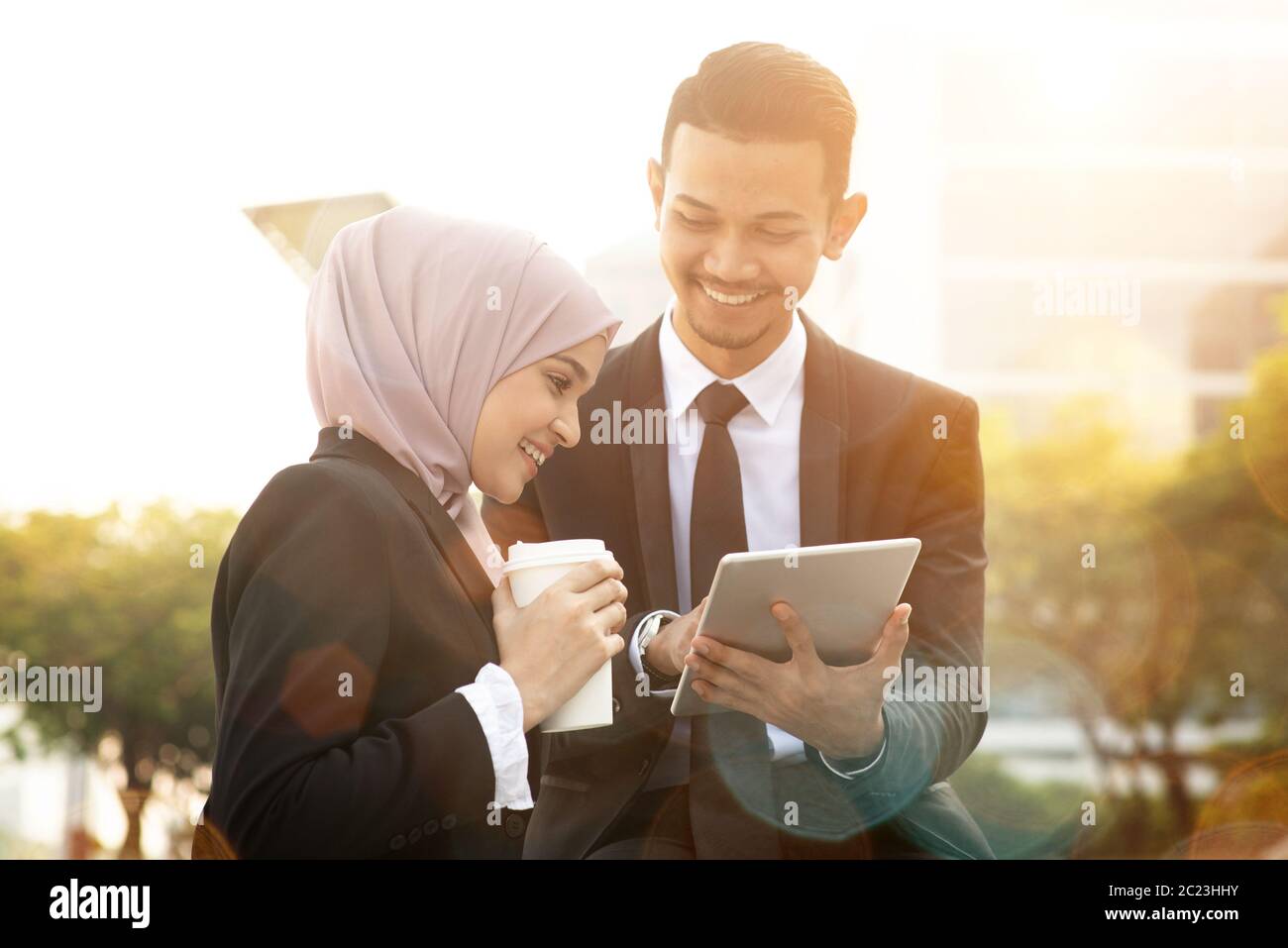 Business team discussing, using tablet pc outside office. Stock Photo