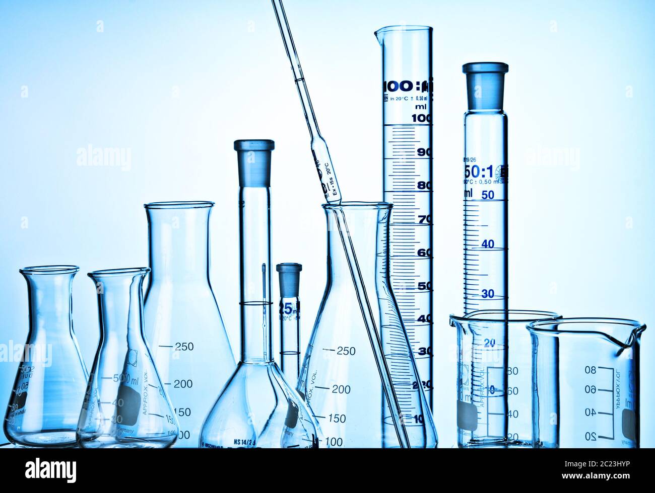 Flask, Measuring Cylinders, Glass Mug and pipette in laboratory Stock
