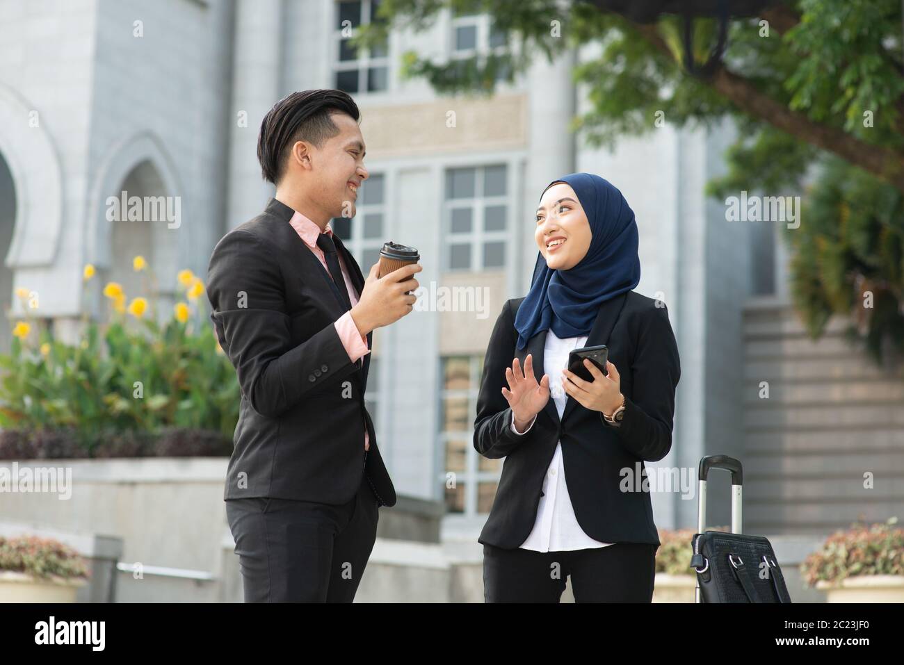 Young entrepreneurs talking outdoor, business travelling. Stock Photo