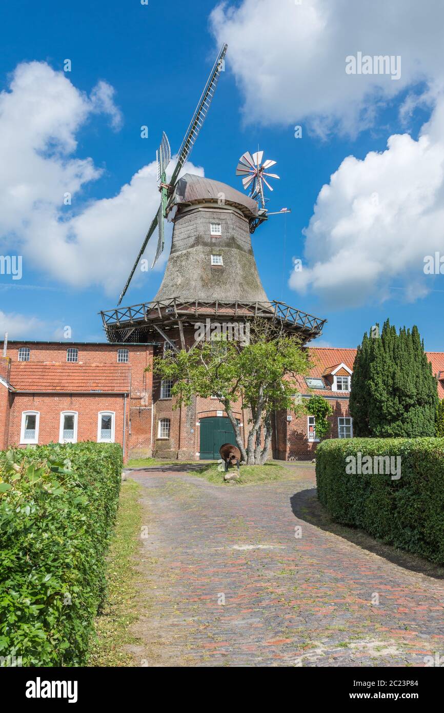 Three-story Smock Mill in Pewsum, Lower Saxon Mill Road, East Frisia, Germany Stock Photo