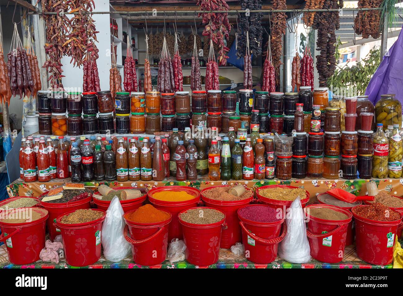 Different spices, dried food and jams in jars in the bazaar known as deserters bazaar, in Tbilisi, Georgia Stock Photo