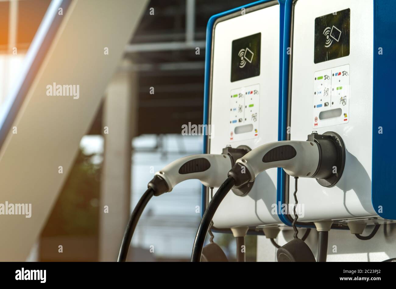 Electric car charging station. Plug for vehicle with electric motor. Coin-operated charging station. Clean energy power. Commercial charging station. Stock Photo