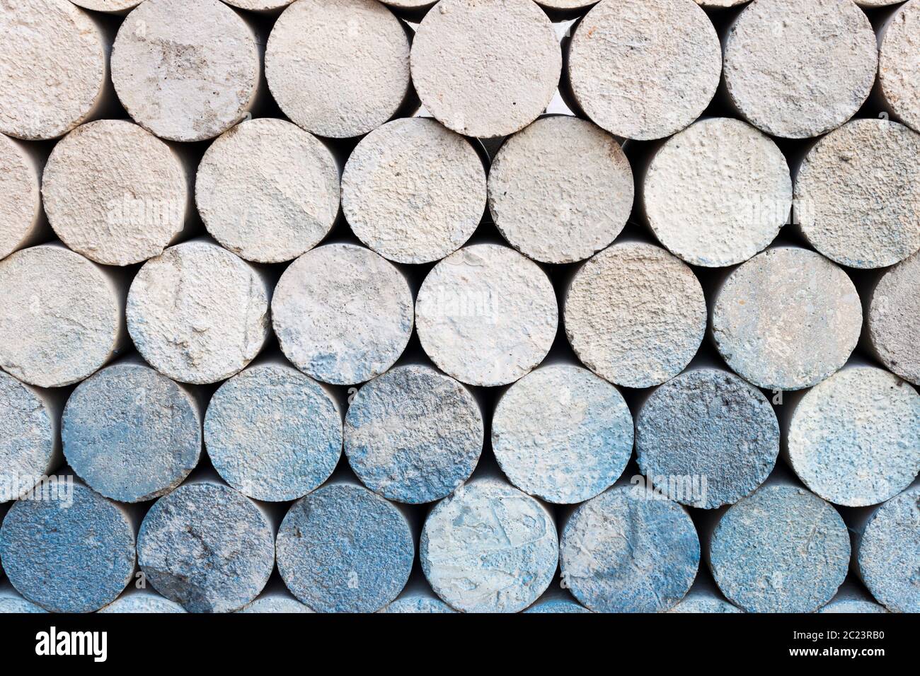 Pile of concrete cylinder bricks. Storage of cylindrical cement samples