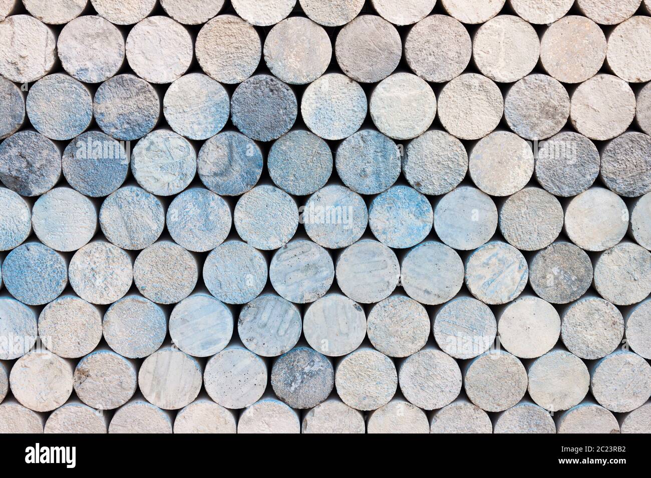Pile of concrete cylinder bricks. Storage of cylindrical cement samples