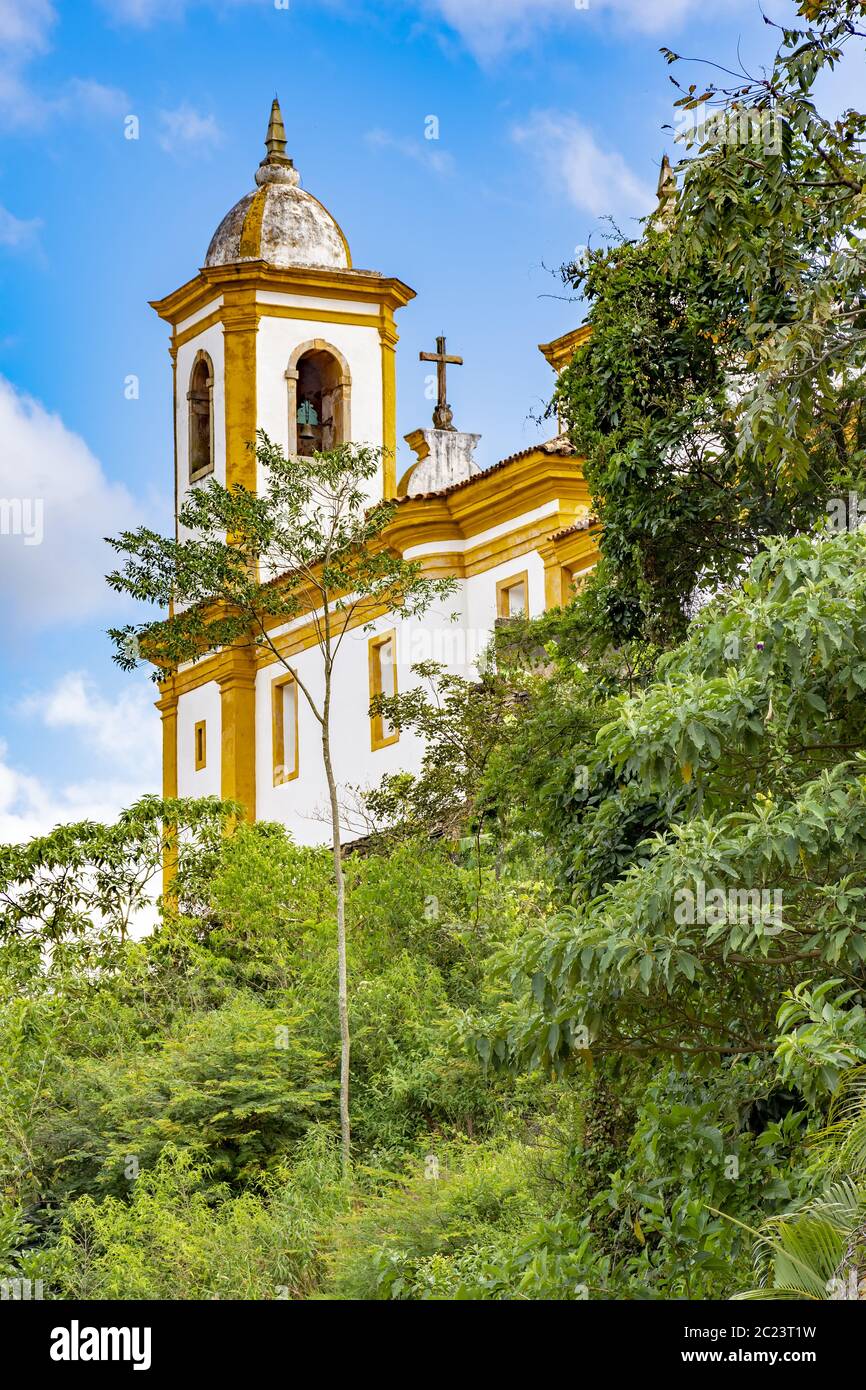 Ancient historical catholic church between vegetation in the city of Ouro Preto Stock Photo