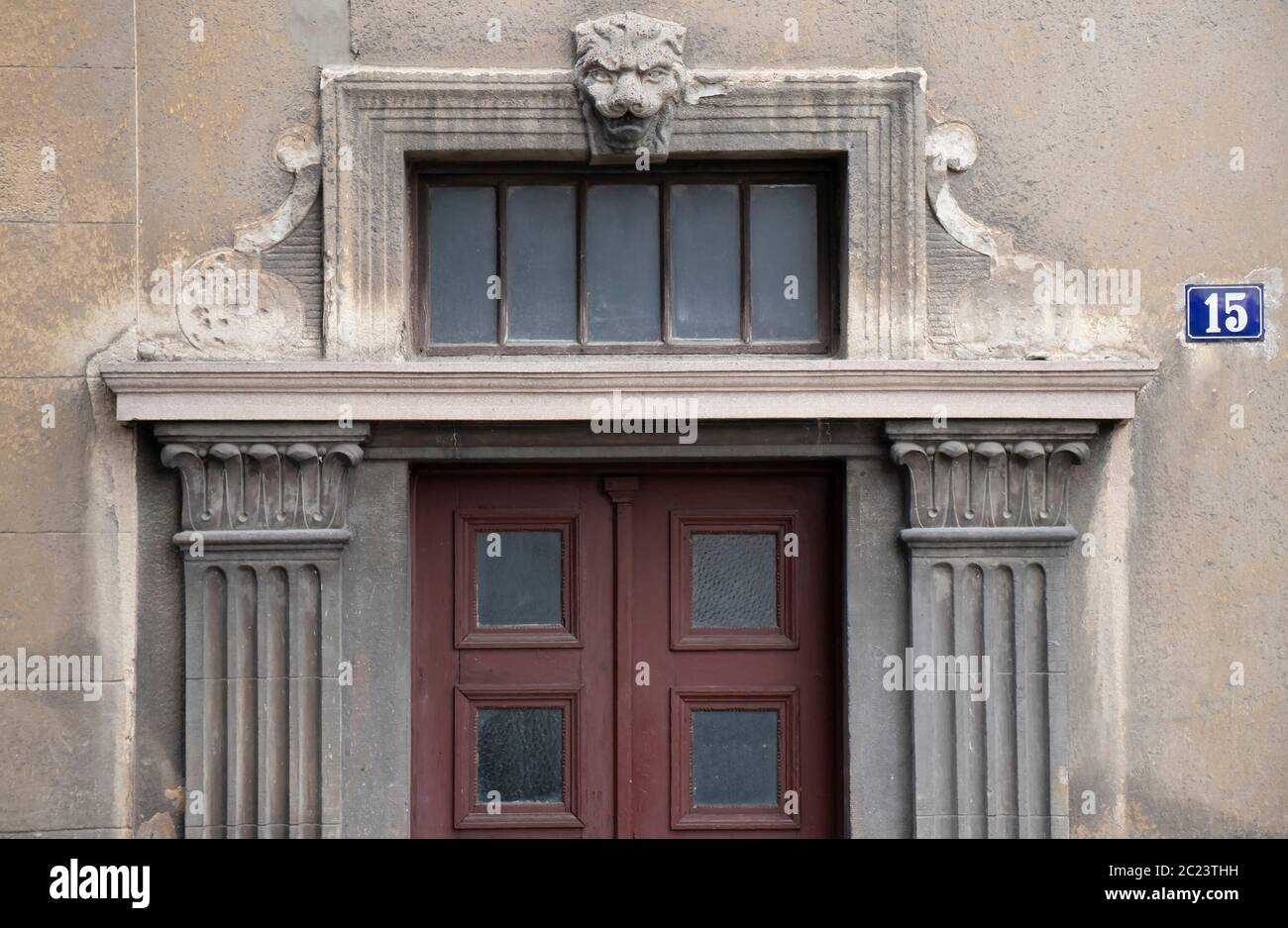 House entrance door with pillars and lion head above , detail of neoclassical Belgrade architecture Stock Photo