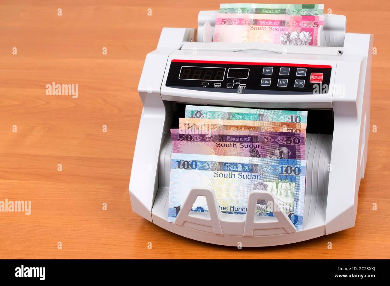 South Sudanese Pounds in a counting machine Stock Photo